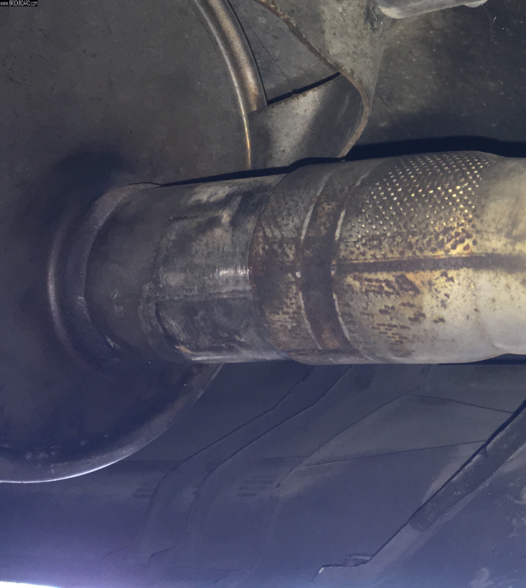 Volvo 200 -- Tailpipe, Loosened but Removal Obstructed (a) at the joint, port side, looking aft.