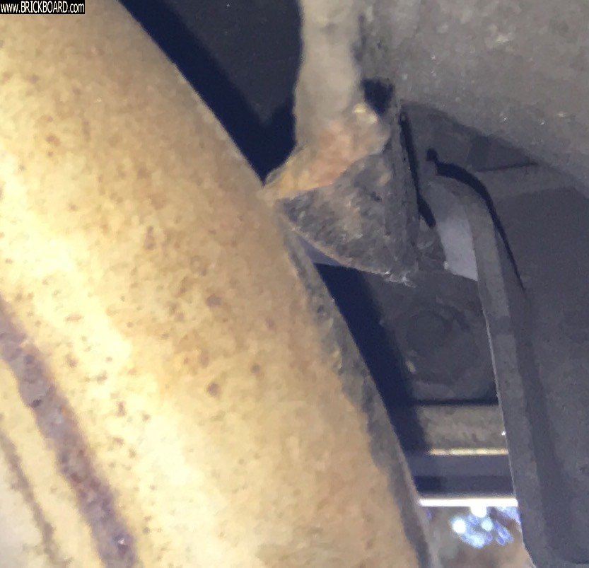 Volvo 200 --    Tailpipe, Loosened but Its Removal Obstructed (b) at the obstruction, port side, looking aft.